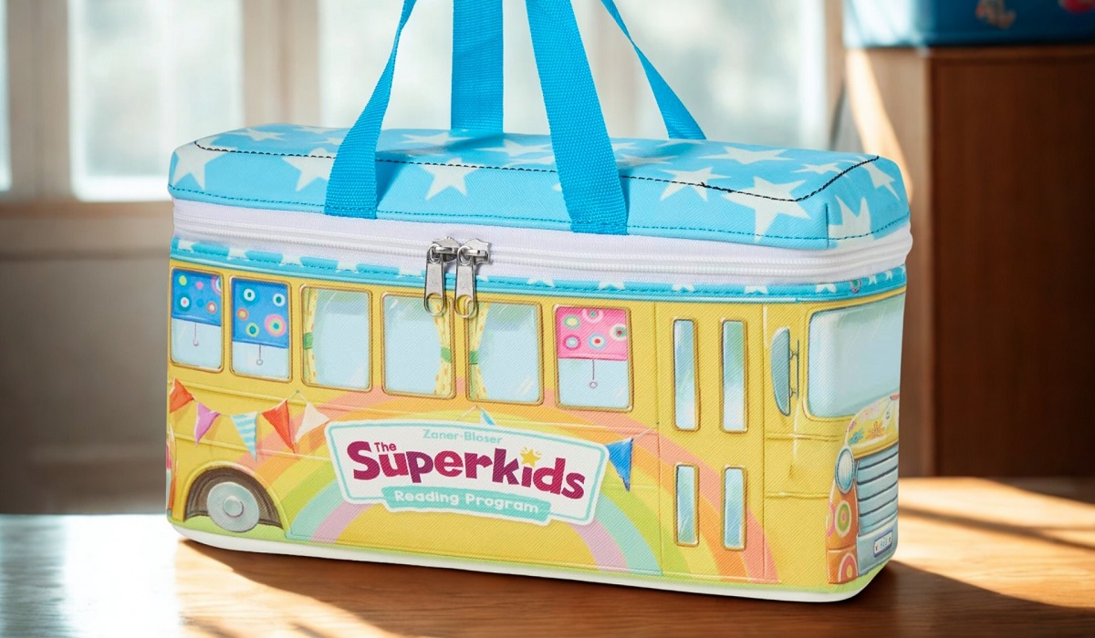 Colorful bus-themed carrying case designed for Zaner-Bloser’s Superkids Reading Program, produced by Continuum as part of a custom curriculum kit solution. The cloth packaging replaced metal for creativity, cost savings, and classroom-ready durability—delivering innovation and efficiency for educators.
