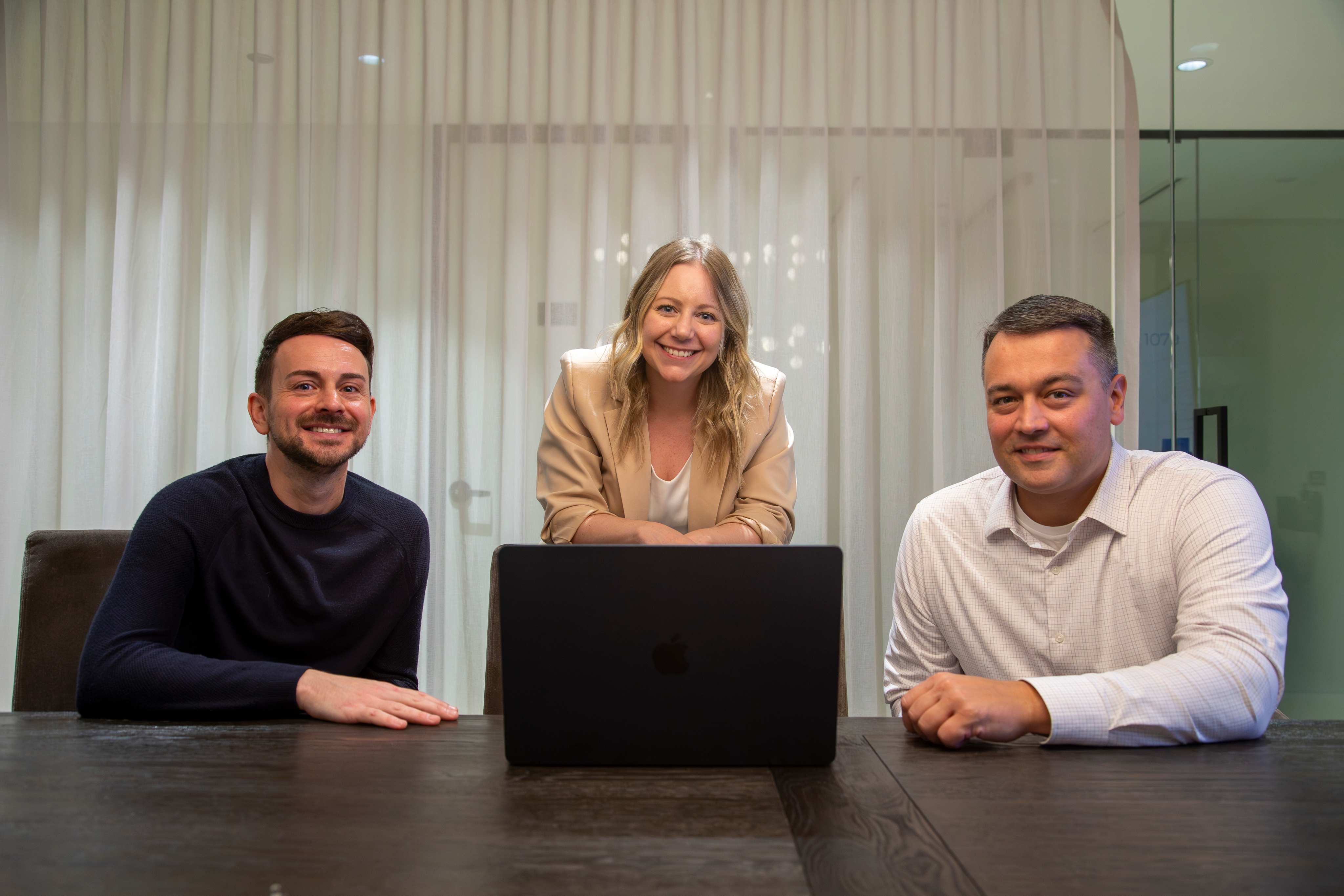 A photo of three Continuum Marketing employees