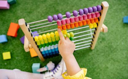Child Using Educational Manipulative Abacus for Learning
