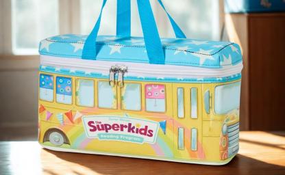 Colorful bus-themed carrying case designed for Zaner-Bloser’s Superkids Reading Program, produced by Continuum as part of a custom curriculum kit solution. The cloth packaging replaced metal for creativity, cost savings, and classroom-ready durability—delivering innovation and efficiency for educators.