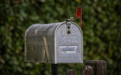 Traditional U.S. mailbox symbolizing direct mail marketing strategy, USPS rate increases, and 2027 postal campaign planning.