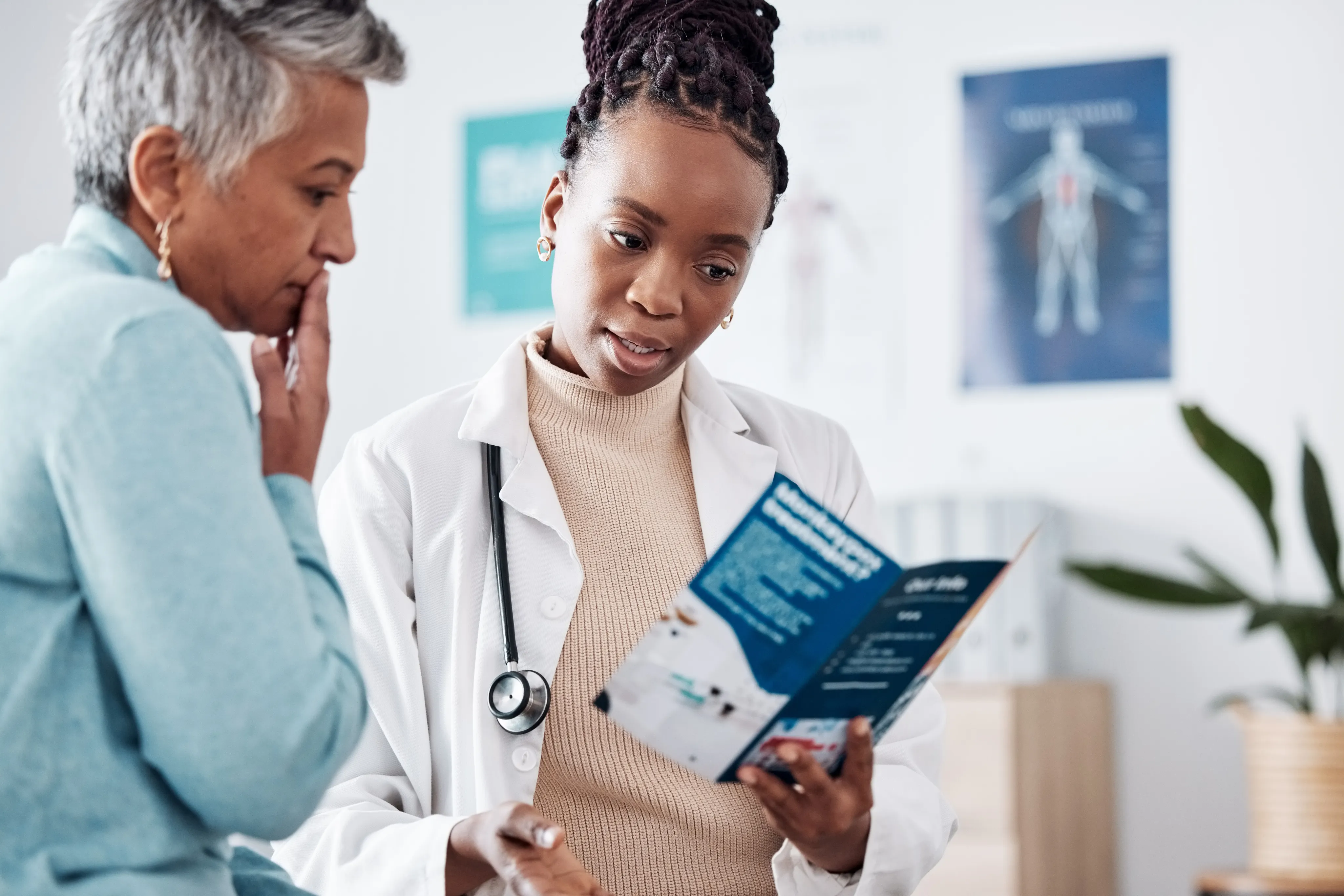 Doctor reviewing a healthcare brochure with a patient.